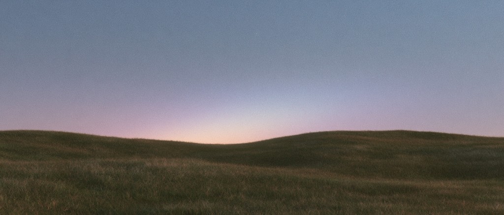 Grainy twilight hills with a glowing peach and lavender horizon
